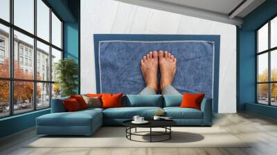 Yoga mat hot bikram yoga class - girl taking pov selfie of feet standing on towel in studio. Top view on floor. Wall mural