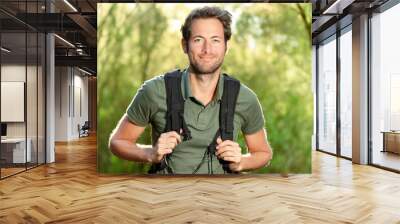 Young man hiking Wall mural