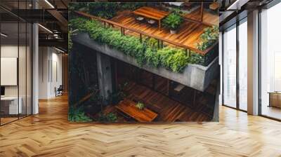 A modern home with plenty of greenery, featuring wooden and concrete details, and a balcony overlooking the garden Wall mural