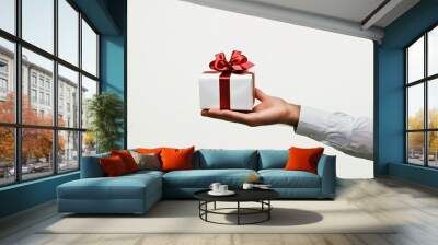  A businessman holds a white gift box with a red ribbon in his hand, isolated on a white background. The concept is to give a business gift, a New Year's gift Wall mural