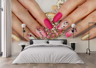 A luxurious manicure with a pink matte finish for nails and a gradient from white with gold to pink nail Polish.Nail art with various shaped rhinestones and colors. Wall mural