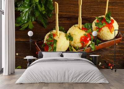 Traditional Italian appetizer, rice balls with cheese. Arancini on a rectangular plate, Close-up. Wall mural