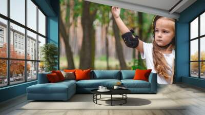 a little girl holding a skateboard, a happy smiling child in a helmet, a concept of children's sports and entertainment Wall mural