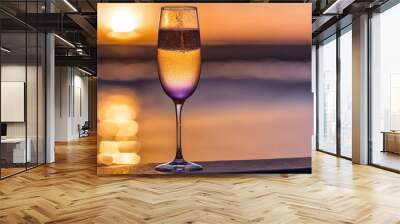 Glass of champagne against the sunset. Landscape, holiday, alcoholic drink. Atmospheric evening Wall mural