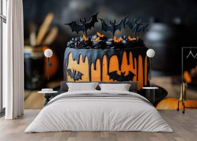 Halloween cake with black and orange dripping frosting decorated with bat shaped topper cutouts. Spooky Halloween food concept.  Wall mural