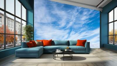 light fluffy clouds on a bright blue sky Wall mural