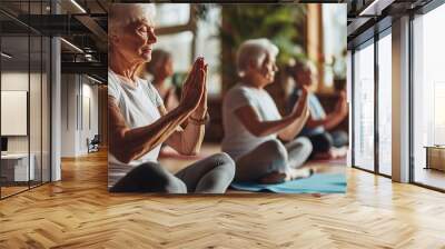 Older women practice yoga, meditate in yoga classes and lead an active and healthy lifestyle. Retirement hobbies and leisure activities for the elderly. Bokeh in the background.  Wall mural