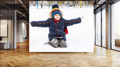 cheerful boy playing in the snow in the open air Wall mural