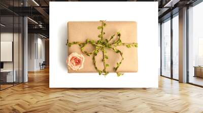 Package, box wrapped in craft paper with rose flower isolated on white. hello spring, zero waste concept. Wall mural