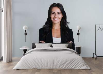 Perfect business lady. Beautiful young businesswoman looking at camera with smile while standing against white background Wall mural