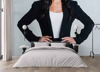 Perfect business woman. Beautiful young businesswoman looking at camera with smile while standing against white background Wall mural