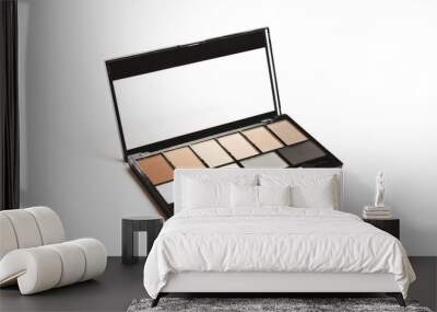 Set of nude brown eyeshadow in a palette in black case on white background Wall mural