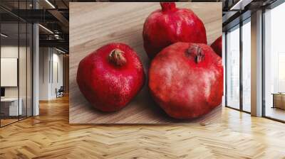 several pomegranate fruits on a wooden background. healthy eating Wall mural