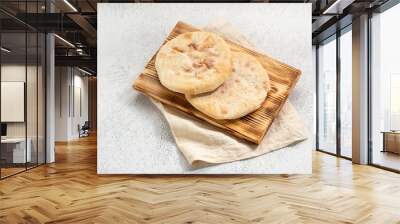 two flat breads on a board and linen napkin Wall mural