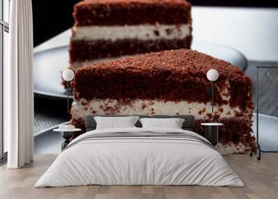 two pieces of chocolate cake on a dark plate Wall mural