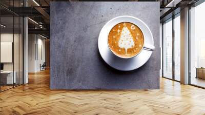 Tasty cappuccino with Christmas tree latte art on grey concrete background. Wall mural