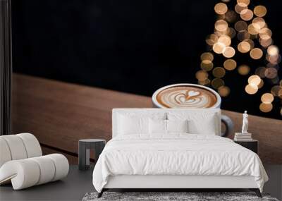 Tasty cappuccino with some blurred lights from Christmas tree. Wall mural