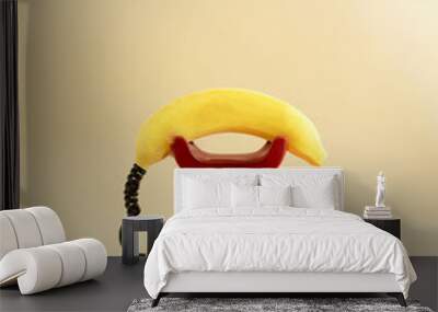 retro red telephone with yellow fresh banana imitating phone handset.aesthetic still design.communication or invitation concept idea Wall mural