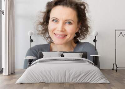 romantic woman looking into camera with smile Wall mural