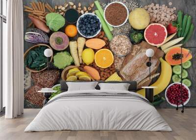 High fibre super food with whole grain bread loaf and rolls, fruit, vegetables, whole wheat pasta, cereals, seeds and nuts. Foods omega 3, anthocyanins, antioxidants and vitamins. Top view. Wall mural