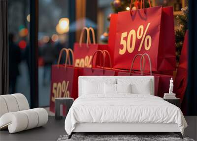 A display of red shopping bags with 50% discount signs, festive decor, on a city street background Wall mural