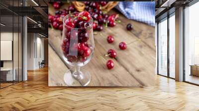 A lot of ripe and sweet cherries, on the table and in a glass, for traditional Belgian beer. Delicious red berries. Copy space, Wall mural