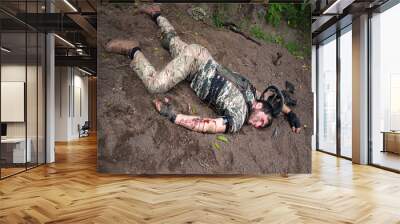 A wounded soldier lies on the ground Wall mural