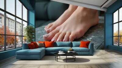 Close-up of woman's feet with elegant nail art pedicure on marbled stone surface
 Wall mural