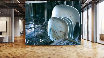 Dirty dishes in dishwashing machine. Making household easy. Technical progress helps keeping clean kitchen Wall mural