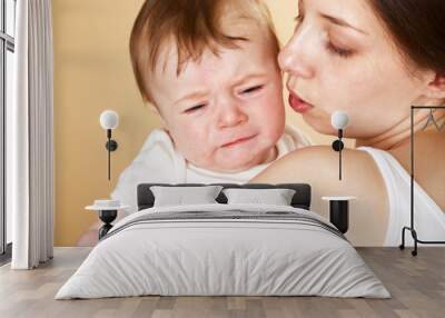 baby boy crying in mothers arm Wall mural