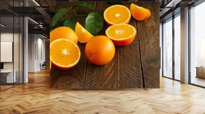 Fresh oranges with green eaves on rustic wooden background with copy cpace. Wall mural