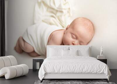 Newborn baby sleeping on a white blanket Wall mural