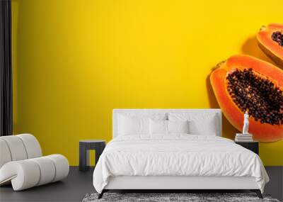 Fresh two halves of papaya on yellow background, top view. Banner. Space for text Wall mural