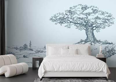 The mighty oak tree grows on top of a hill Wall mural