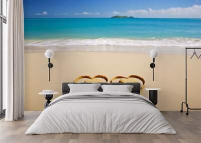 Two hearts of sand on the beach against the background of the sea and the blue sky with clouds Wall mural