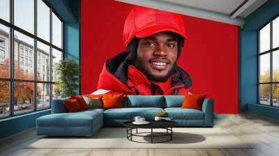 A cheerful young man in a vibrant red winter jacket against a bold backdrop. Generative AI Wall mural