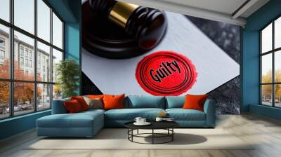 Red wax seal proclaiming guilt alongside a gavel on a dark surface captures legal judgment Wall mural