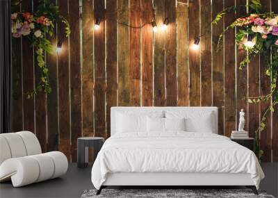 wooden wall with lamps and flowers. copy space Wall mural