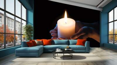 Women's hands holding a candle Wall mural