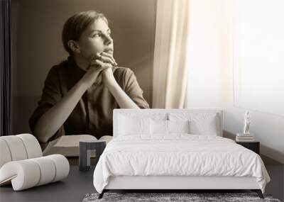 Young girl with old book Wall mural