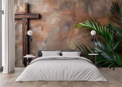 Palm Sunday theme: wooden cross and green palm leaves on background of plastered painted brown wall with place to copy the text. Religion, faith, Christianity. Concept of Holy Week. Copy space. Wall mural