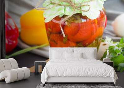 Jars of tasty pickled vegetables on a table. Creative atmospheric decoration. Wall mural