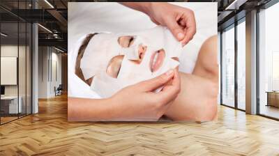 Beautiful woman with facial mask Wall mural