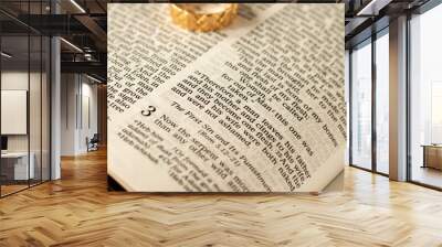 Christian marriage and family, a blessing from God and Jesus Christ. Biblical concept. Open Holy Bible with a gold ring on a book of genesis. Husband and wife faithful love relationship and unity. Wall mural