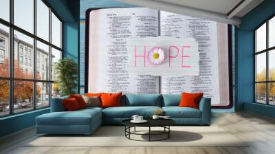 Hope handwritten word on paper with a flower on open holy bible book. Top view. Christian biblical concept. Wall mural