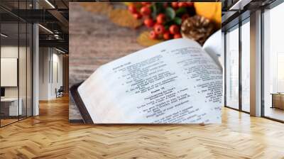 Open holy bible book and autumn fruit and leaves in the background. Christian thanksgiving and gratitude to God Jesus Christ, biblical concept. Wall mural