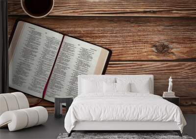 Open Holy Bible Book on wooden table background with a cup of coffee with copy space for text. The biblical concept of reading and studying the Scripture given by God Jesus Christ. Top view. Wall mural