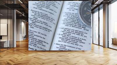 Open holy bible book with compass. Close-up. Christian biblical concept of God's guidance, instruction, teaching, and counsel. Wall mural