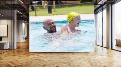 hipster father playing with her daughter in the pool Wall mural