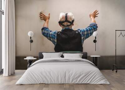 mature man is looking through the viewer of virtual reality Wall mural